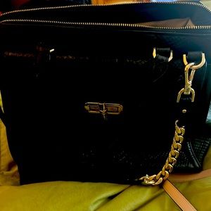 Gorgeous black  scalloped Brahmin bag with gold metal chain straps.